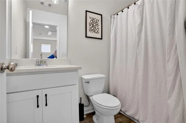 a bathroom with a sink toilet and a mirror