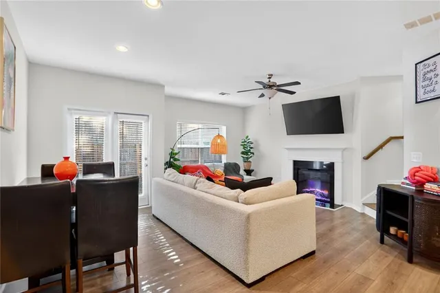 a living room with furniture a fireplace and a flat screen tv
