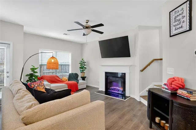 a living room with furniture fireplace and flat screen tv
