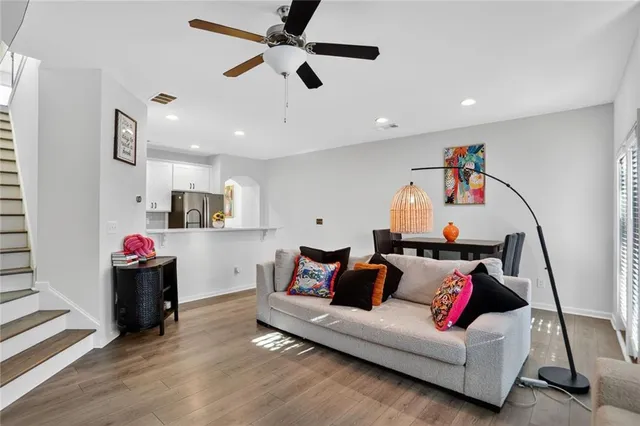 a living room with furniture and kitchen view