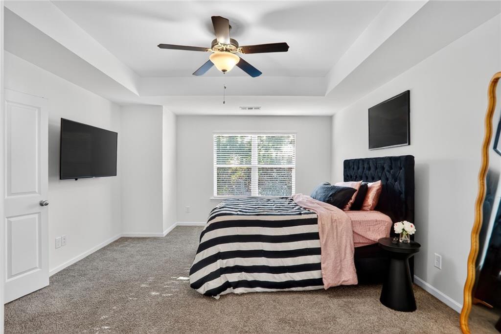 4125 Spring Valley Circle, Unit 7 Tucker, GA 30084 - Photo 10 of 20 a bedroom with a bed tv and a window