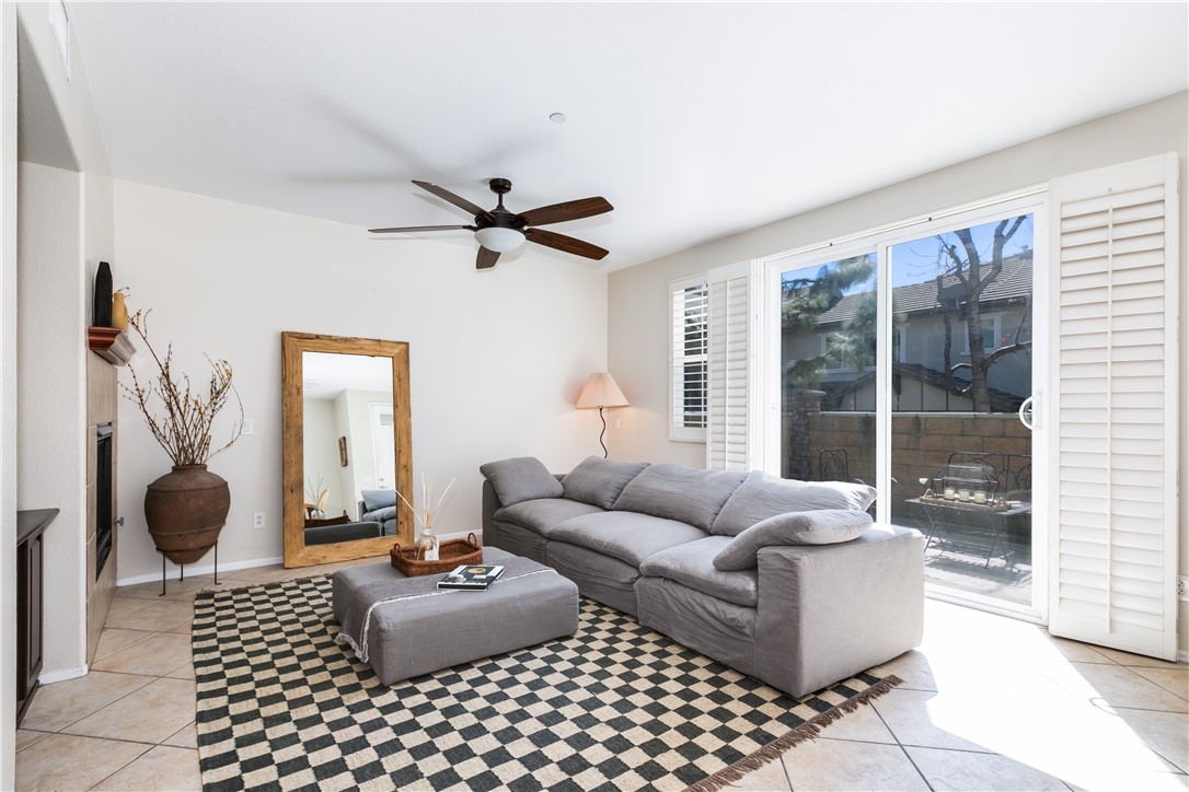 8031 Pueblo Place, Unit 101 Rancho Cucamonga, CA 91730 - Photo 1 of 1 a living room with furniture and a large window
