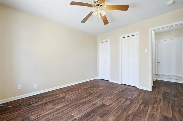 a view of room with wooden floor