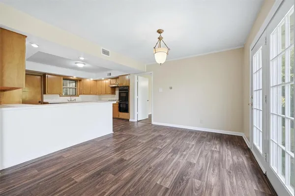 a view of large kitchen with wooden floor and windows