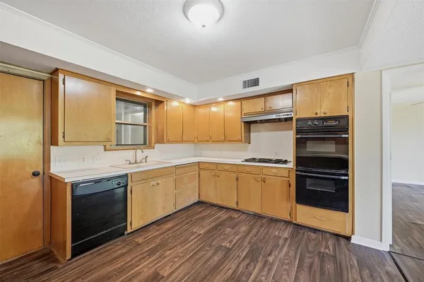 a kitchen with stainless steel appliances granite countertop a stove and a sink