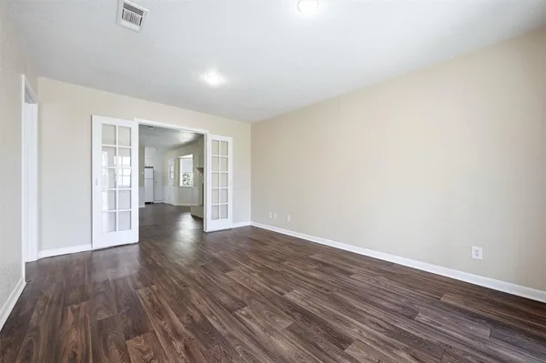 a view of an empty room and wooden floor