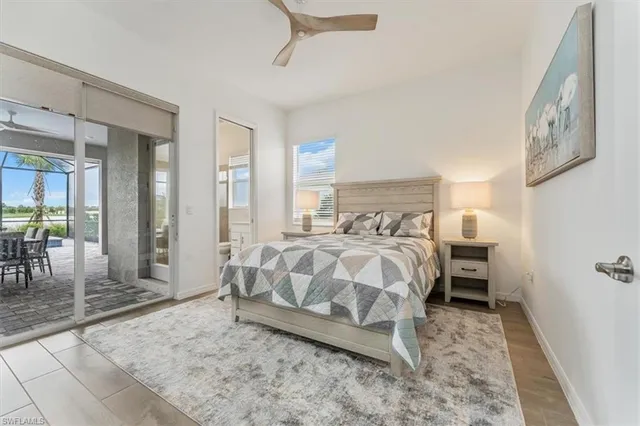 a bedroom with a bed a table and painting on the wall