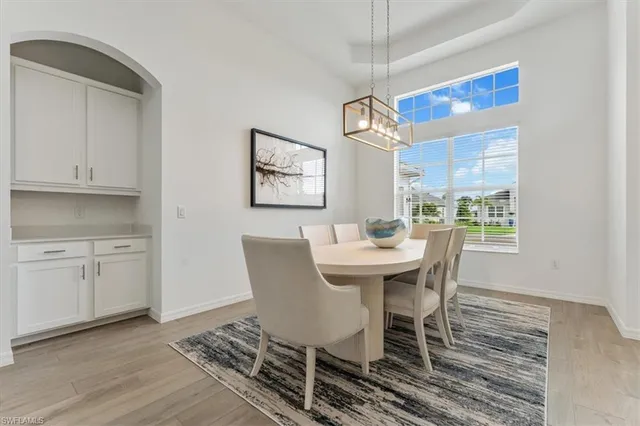 a view of a dining room with furniture wooden floor and chandelier