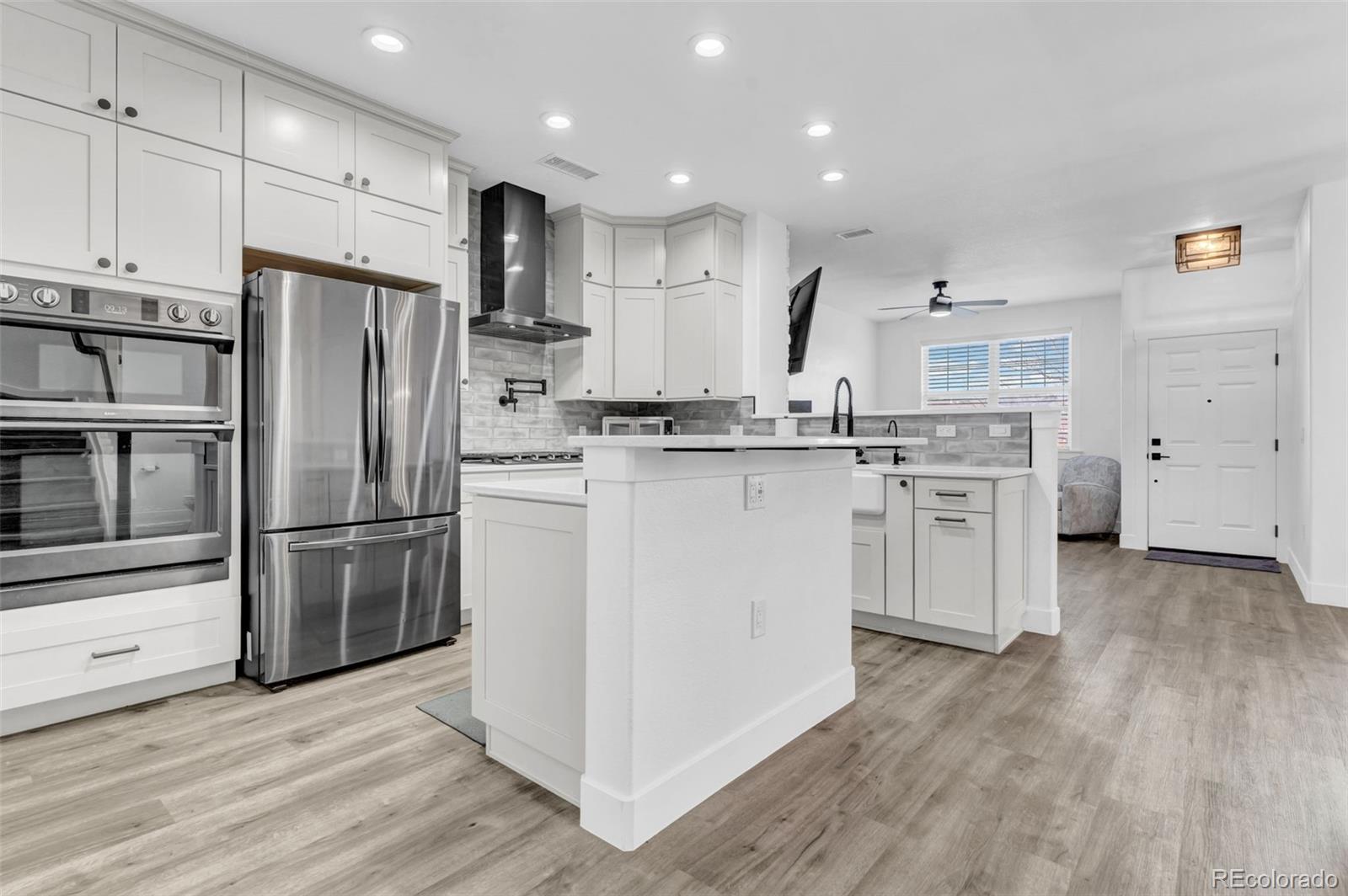3672 South Perth Circle, Unit 105 Aurora, CO 80013 - Photo 1 of 19 a kitchen with stainless steel appliances granite countertop a refrigerator a stove a sink and white cabinets