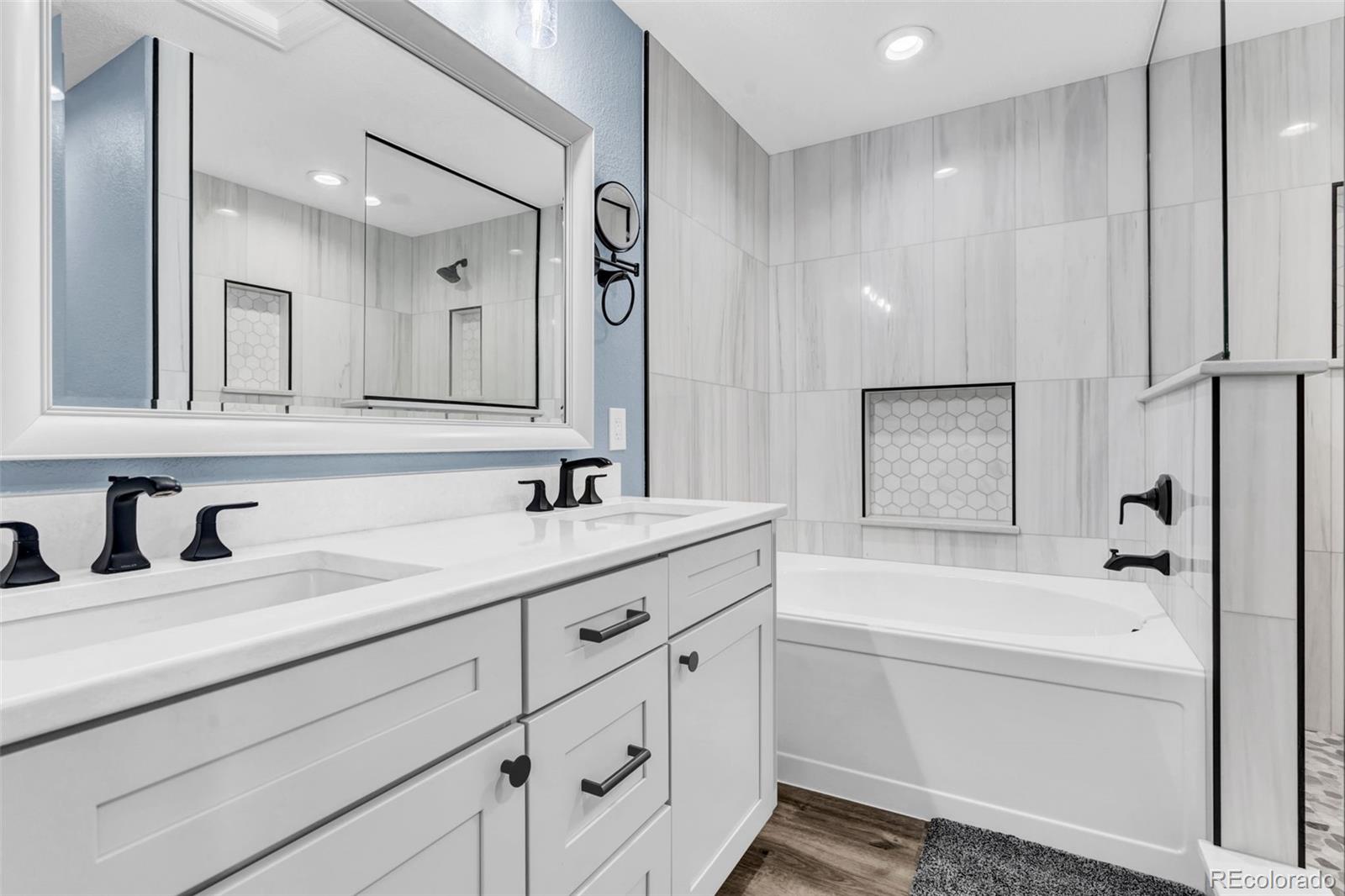 3672 South Perth Circle, Unit 105 Aurora, CO 80013 - Photo 11 of 19 a bathroom with a bathtub shower sink vanity and mirror
