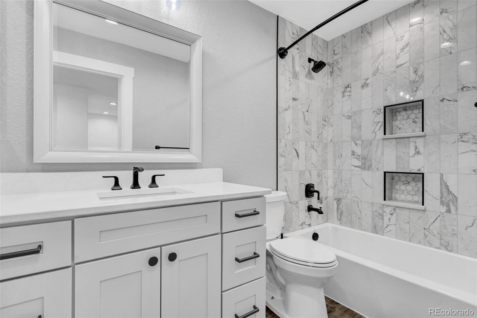 3672 South Perth Circle, Unit 105 Aurora, CO 80013 - Photo 12 of 19 a bathroom with a sink a toilet and a bathtub