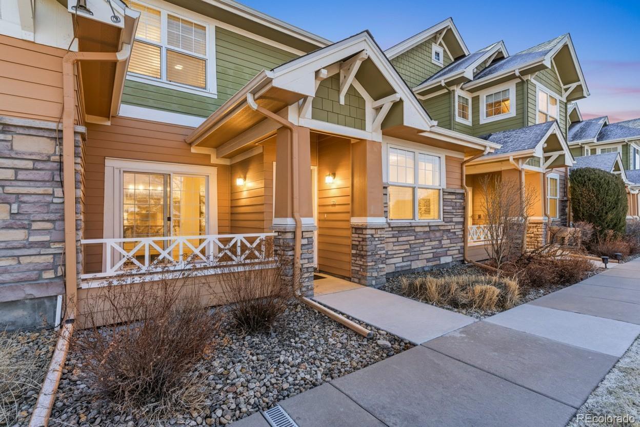 3672 South Perth Circle, Unit 105 Aurora, CO 80013 - Photo 16 of 19 a view of a white house with large windows and couches