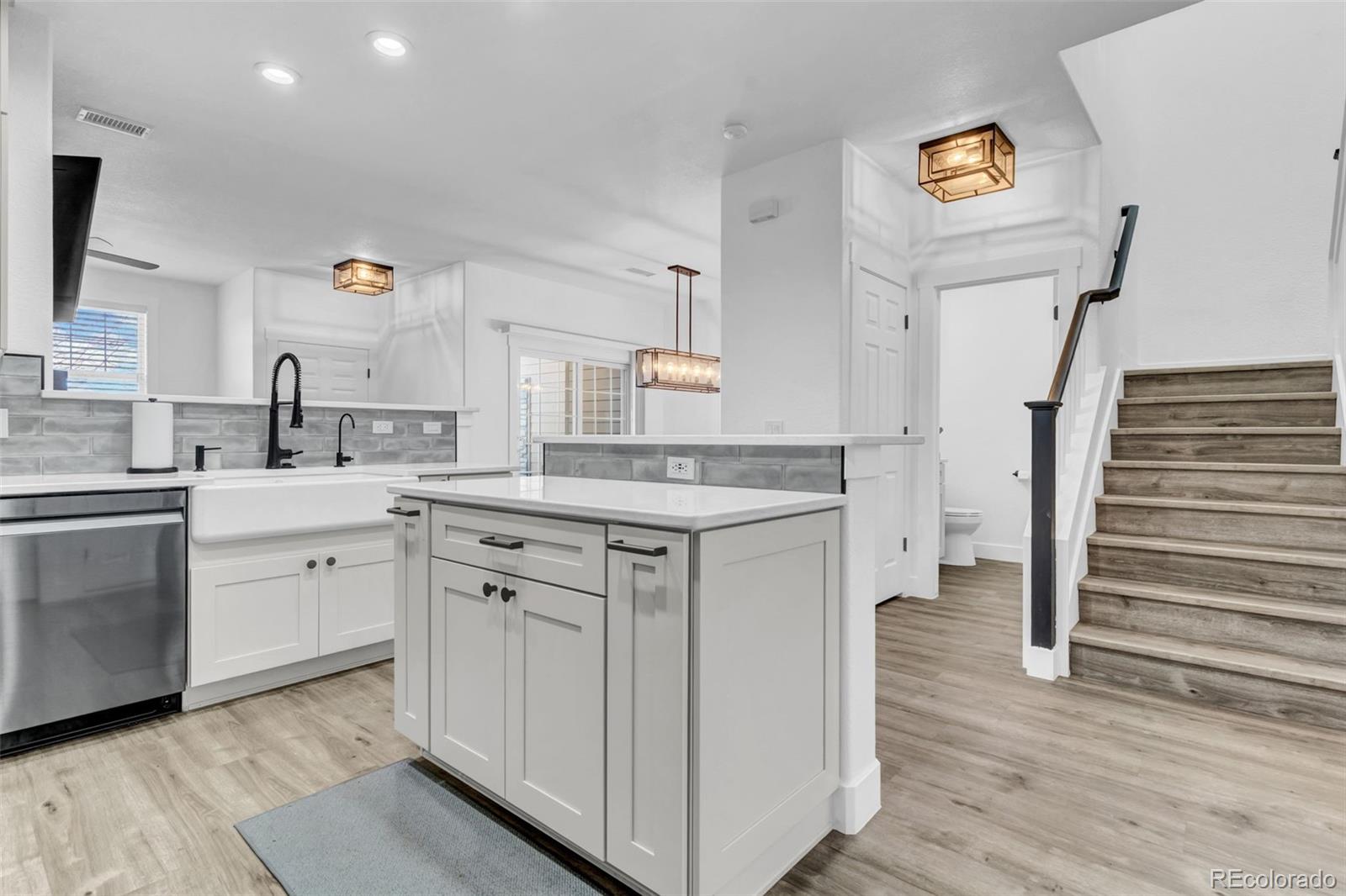 3672 South Perth Circle, Unit 105 Aurora, CO 80013 - Photo 2 of 19 a kitchen with cabinets appliances and a wooden floor