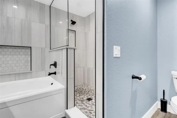 a bathroom with a bathtub and a shower