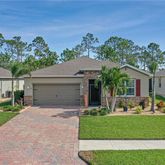a front view of a house with a yard and outdoor seating