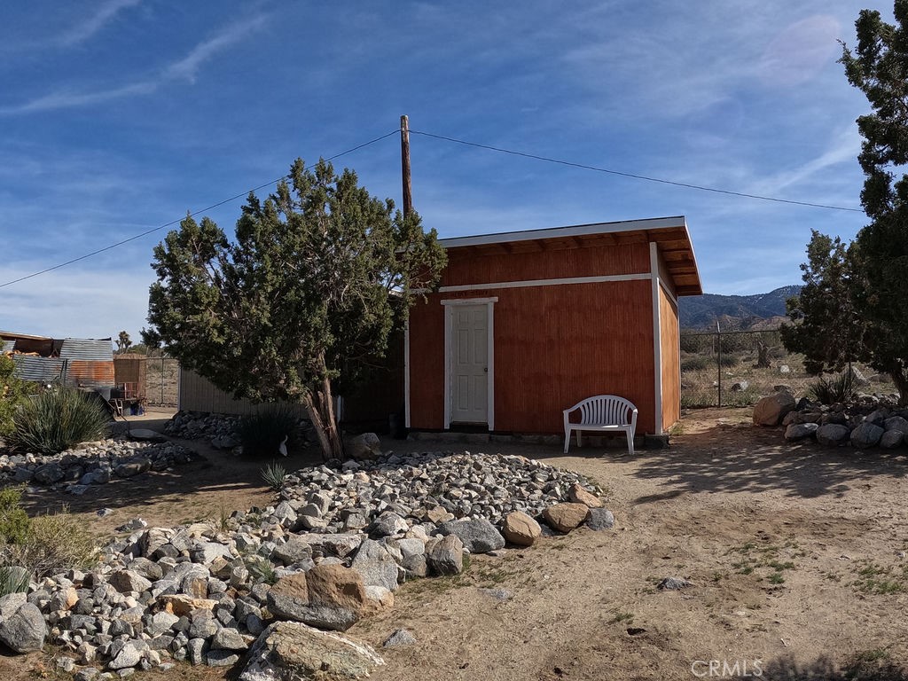 30000 Buchannon Ranch Road Llano, CA 93544 - Photo 15 of 67 a front view of a house with a yard