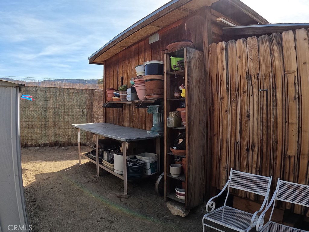 30000 Buchannon Ranch Road Llano, CA 93544 - Photo 44 of 67 a backyard of a house with barbeque oven and outdoor seating