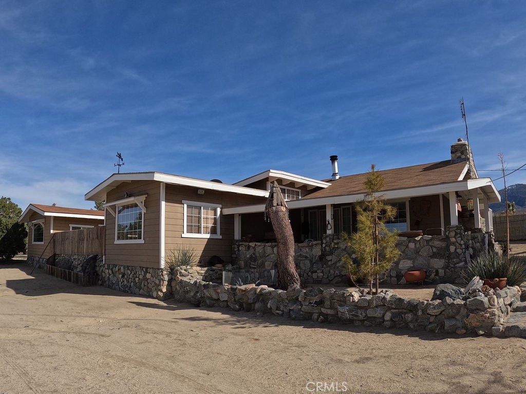 30000 Buchannon Ranch Road Llano, CA 93544 - Photo 46 of 64 a front view of a house with garden