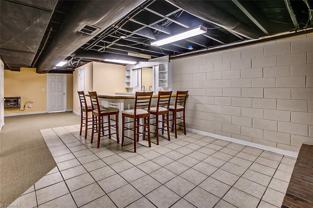 682 Inwood Road Asheboro, NC 27205 - Photo 27 of 40 Semi-finished basement Kitchen area, ceramic floor & eat-at bar (not included in sq footage)