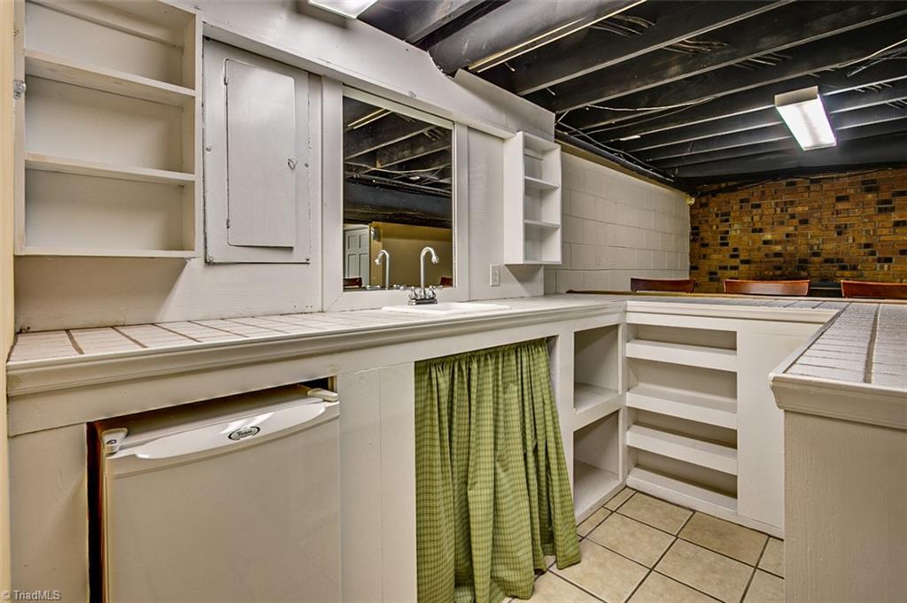 682 Inwood Road Asheboro, NC 27205 - Photo 28 of 40 Semi-finished basement Kitchen area, sink & mini fridge(not included in sq footage)
