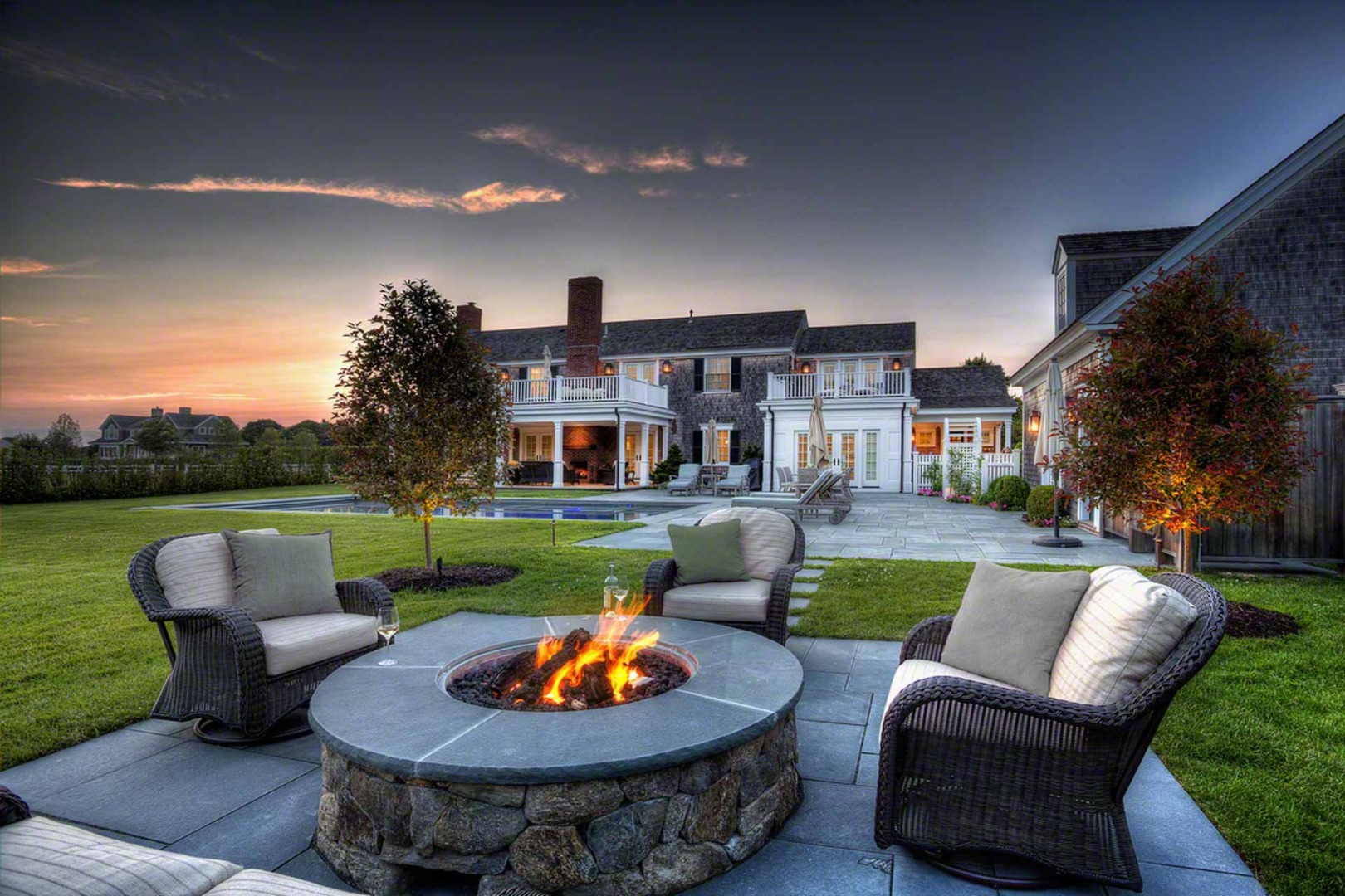a view of a patio with couches chairs and a fire pit