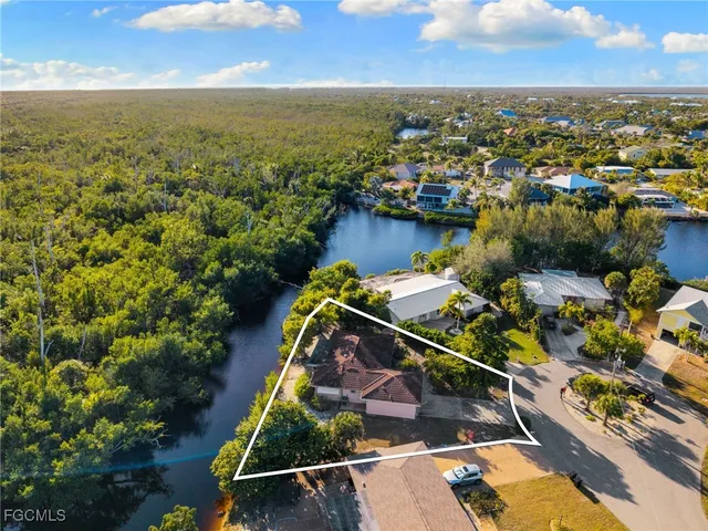 an aerial view of a house with a ocean view