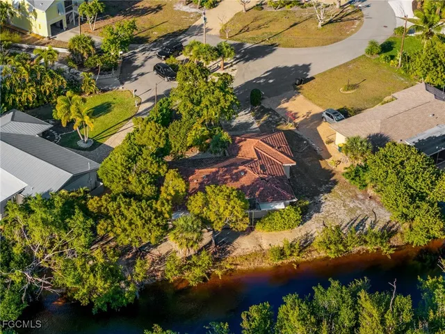 an aerial view of a residential houses with yard