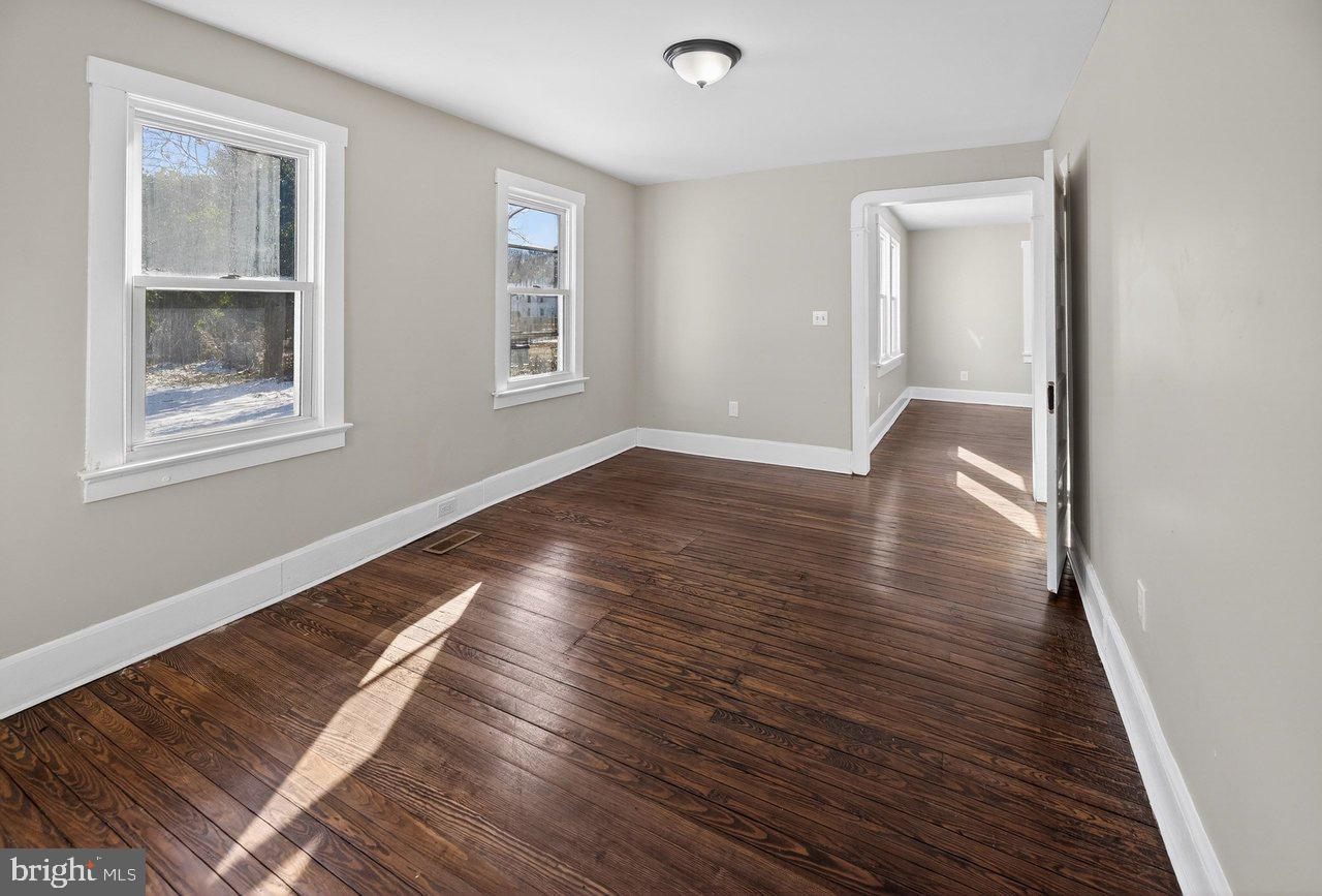 26 Olive Street Salem, NJ 08079 - Photo 14 of 33 a view of an empty room with wooden floor and a window