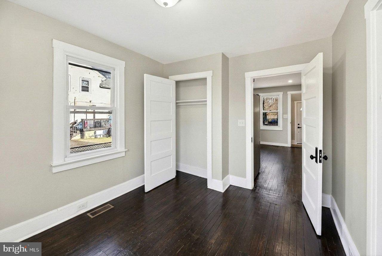 26 Olive Street Salem, NJ 08079 - Photo 15 of 33 an empty room with wooden floor and windows