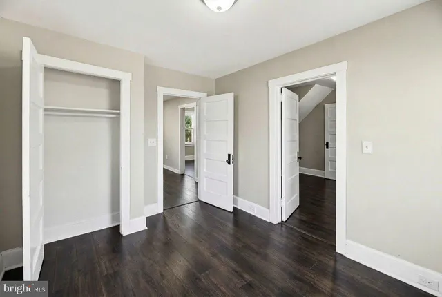 a view of a hallway with wooden floor and entryway