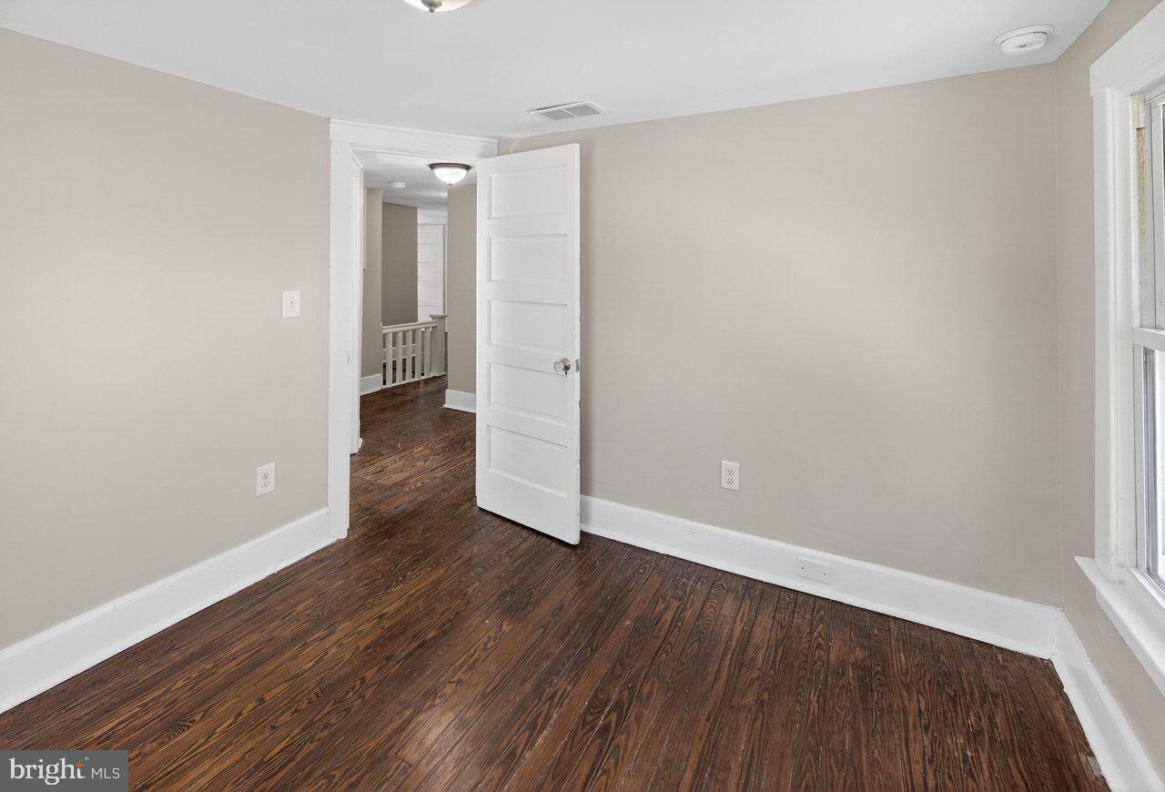 26 Olive Street Salem, NJ 08079 - Photo 22 of 33 a view of an empty room with wooden floor