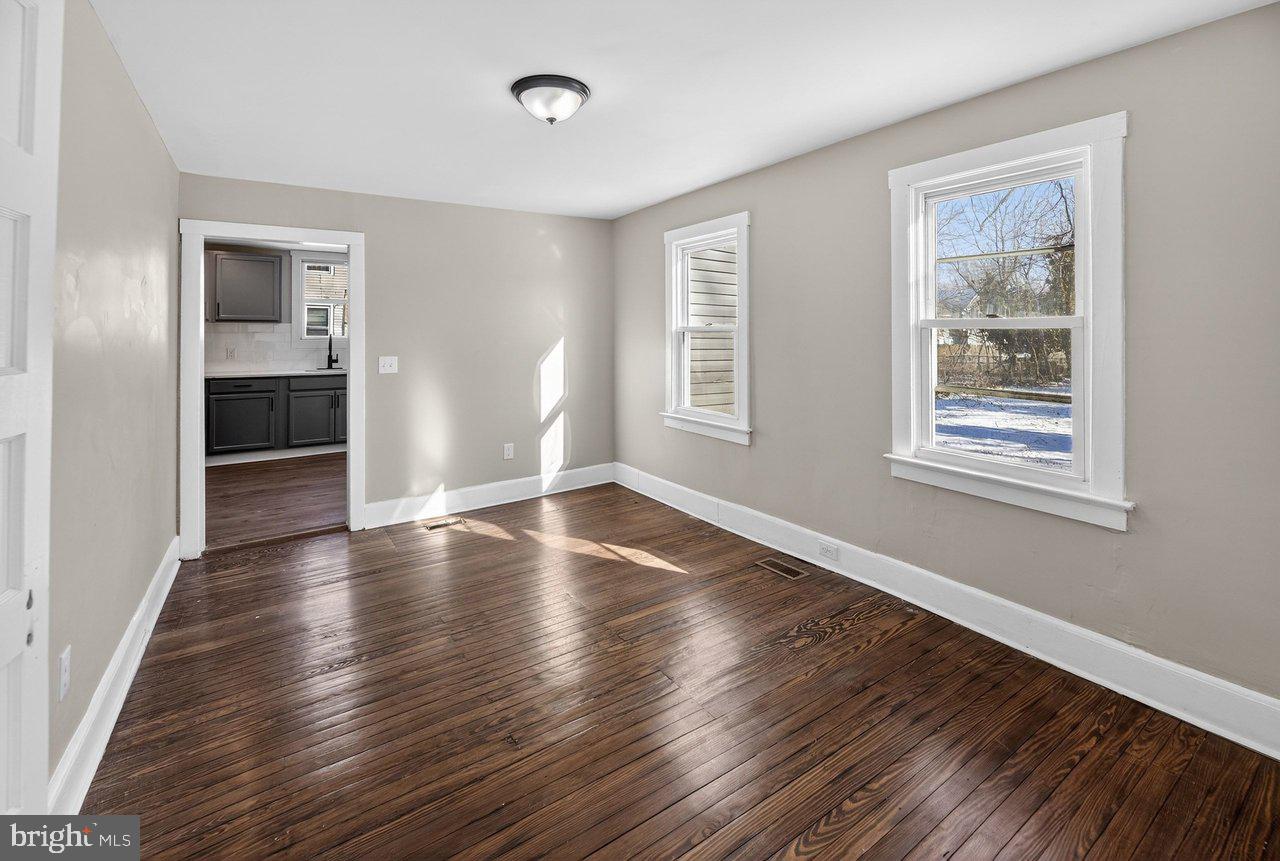 26 Olive Street Salem, NJ 08079 - Photo 27 of 33 an empty room with wooden floor and windows