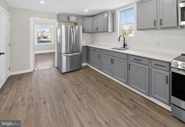 a view of wooden floor and windows in a room