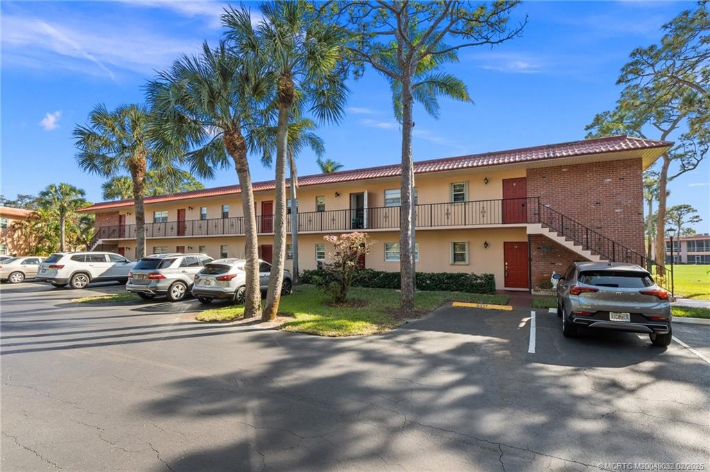 1907 Southwest Palm City Road, Unit 4J Stuart, FL 34994 - Photo 2 of 34 a view of street with parked cars