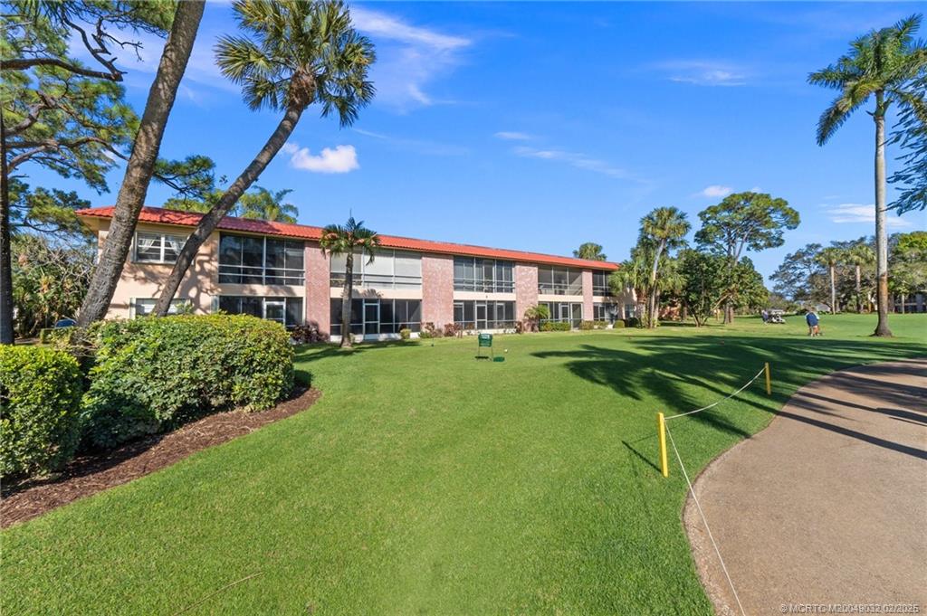 1907 Southwest Palm City Road, Unit 4J Stuart, FL 34994 - Photo 22 of 34 a view of a house with a big yard
