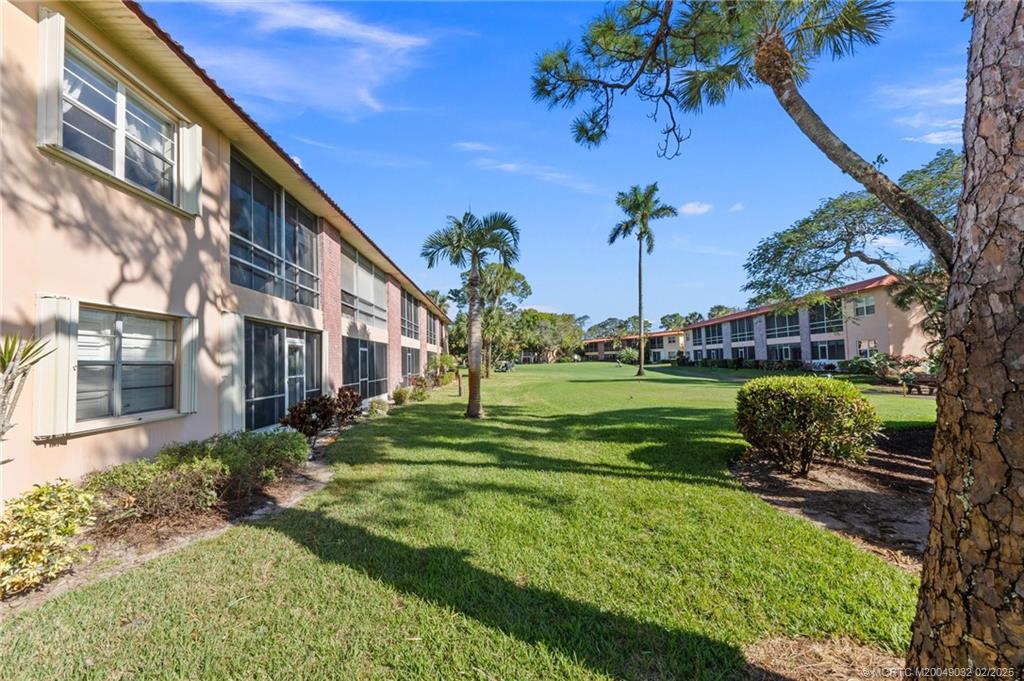 1907 Southwest Palm City Road, Unit 4J Stuart, FL 34994 - Photo 23 of 34 a view of a garden in front of a building