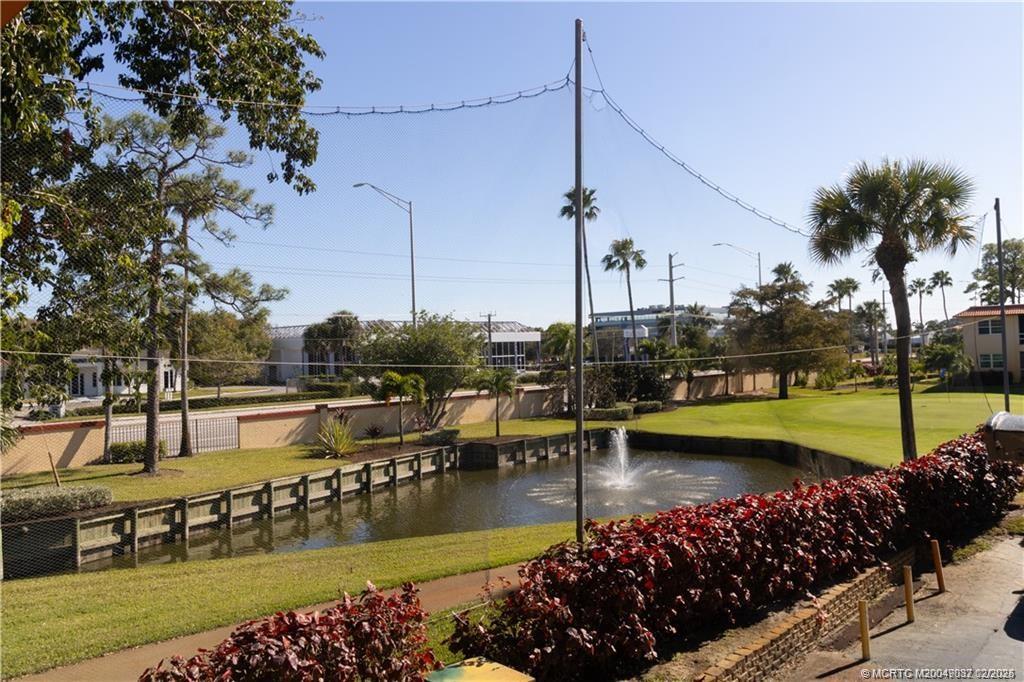 1907 Southwest Palm City Road, Unit 4J Stuart, FL 34994 - Photo 30 of 34 a view of a lake with boats and trees around