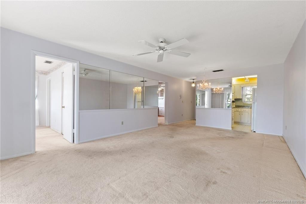 1907 Southwest Palm City Road, Unit 4J Stuart, FL 34994 - Photo 8 of 34 a view of empty room with a kitchen