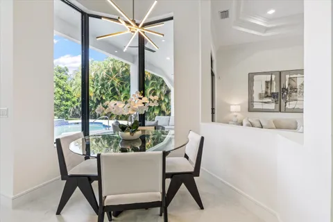 a dining room with furniture and wooden floor