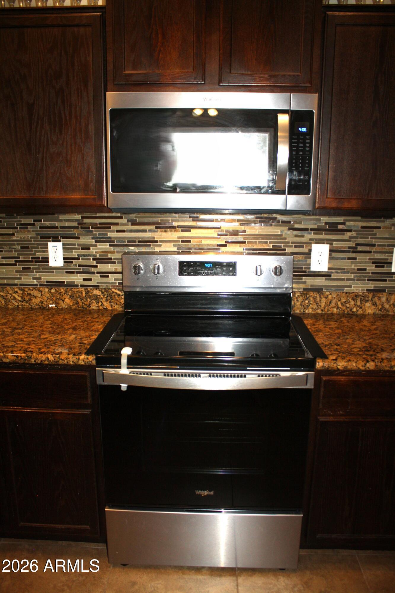10225 West Camelback Road, Unit 19 Phoenix, AZ 85037 - Photo 11 of 51 a stove top oven sitting inside of a kitchen