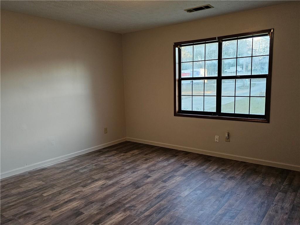 2835 Springdale Road, Unit B Snellville, GA 30039 - Photo 11 of 20 an empty room with wooden floor and windows