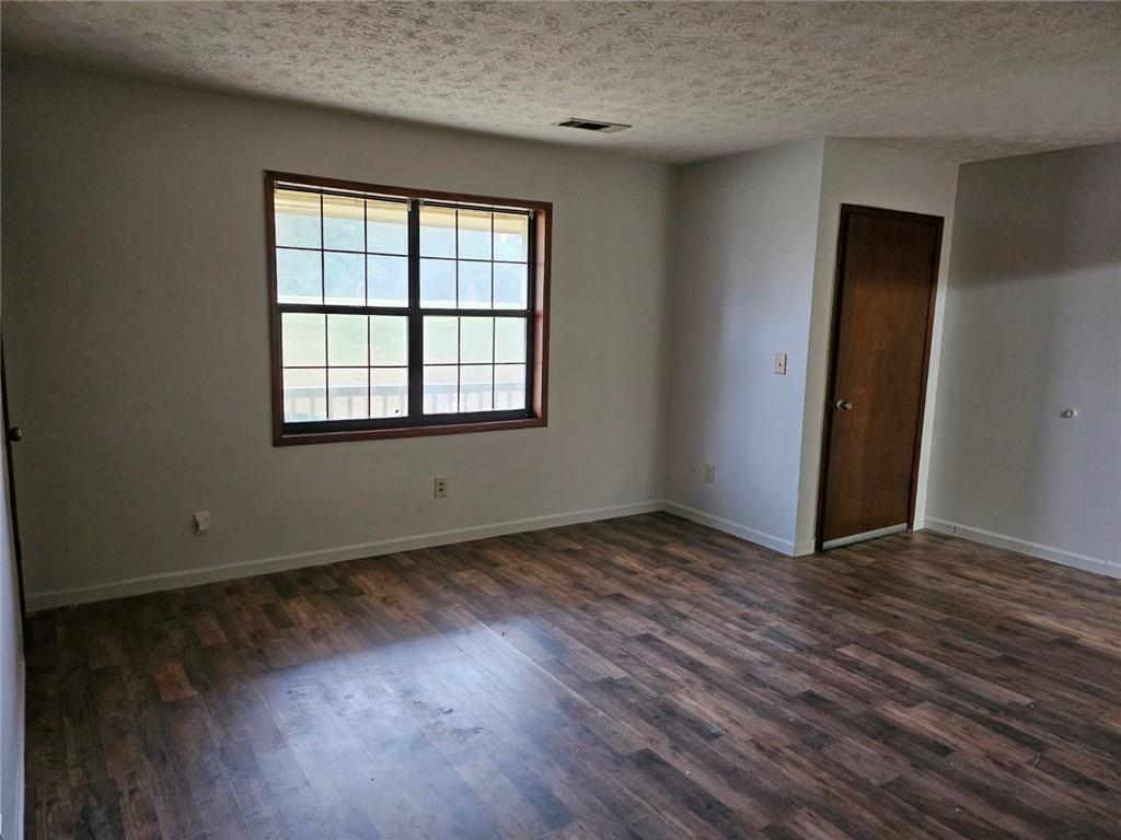 2835 Springdale Road, Unit B Snellville, GA 30039 - Photo 2 of 20 an empty room with wooden floor and windows