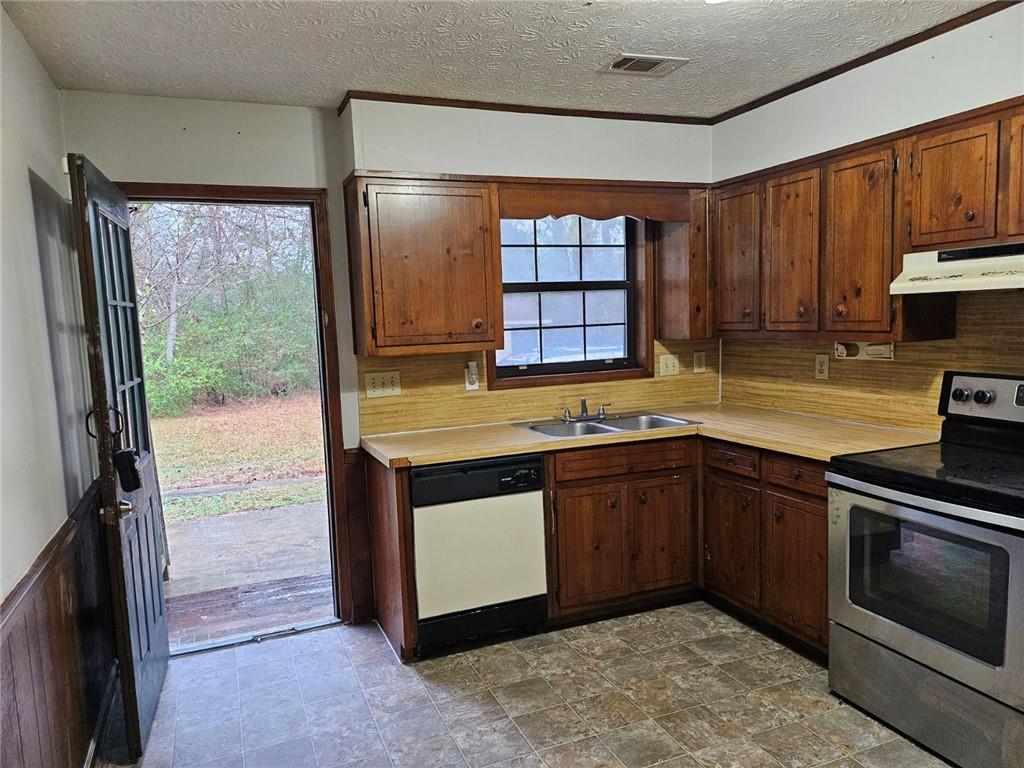2835 Springdale Road, Unit B Snellville, GA 30039 - Photo 7 of 20 a kitchen with stainless steel appliances granite countertop a stove a sink and a microwave