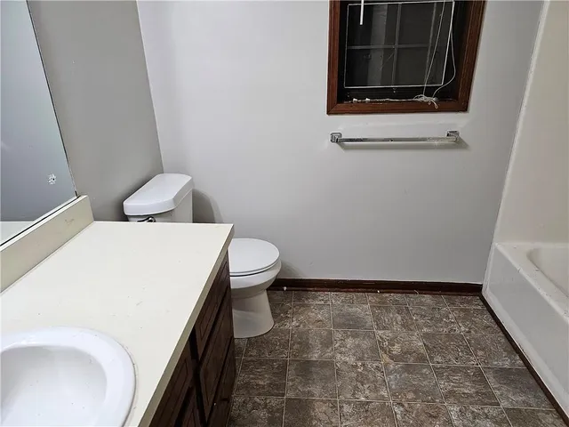 a bathroom with a toilet and a sink