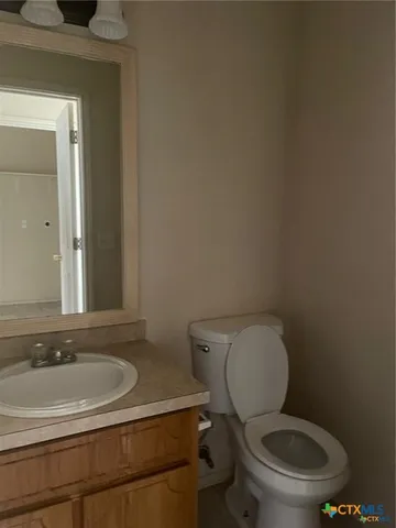 a white toilet sitting next to a bathroom sink