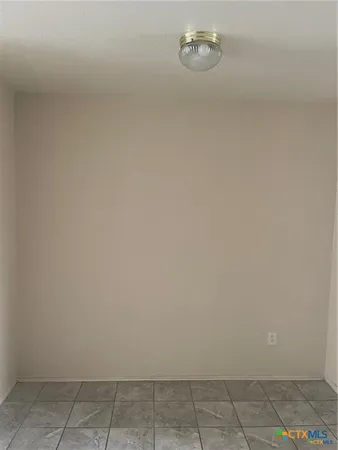 a utility room with cabinets washer and dryer