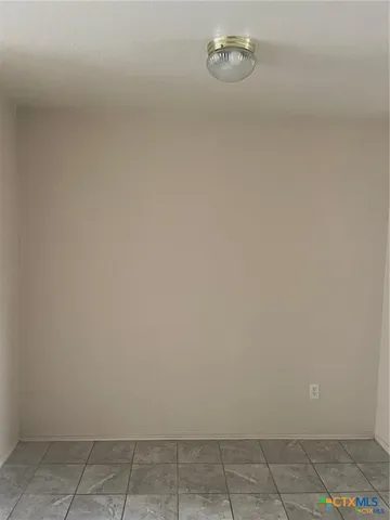 a utility room with cabinets washer and dryer