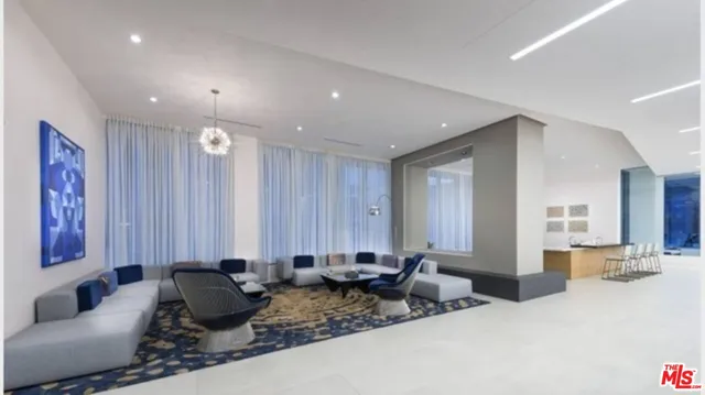 a living room with furniture and large mirror