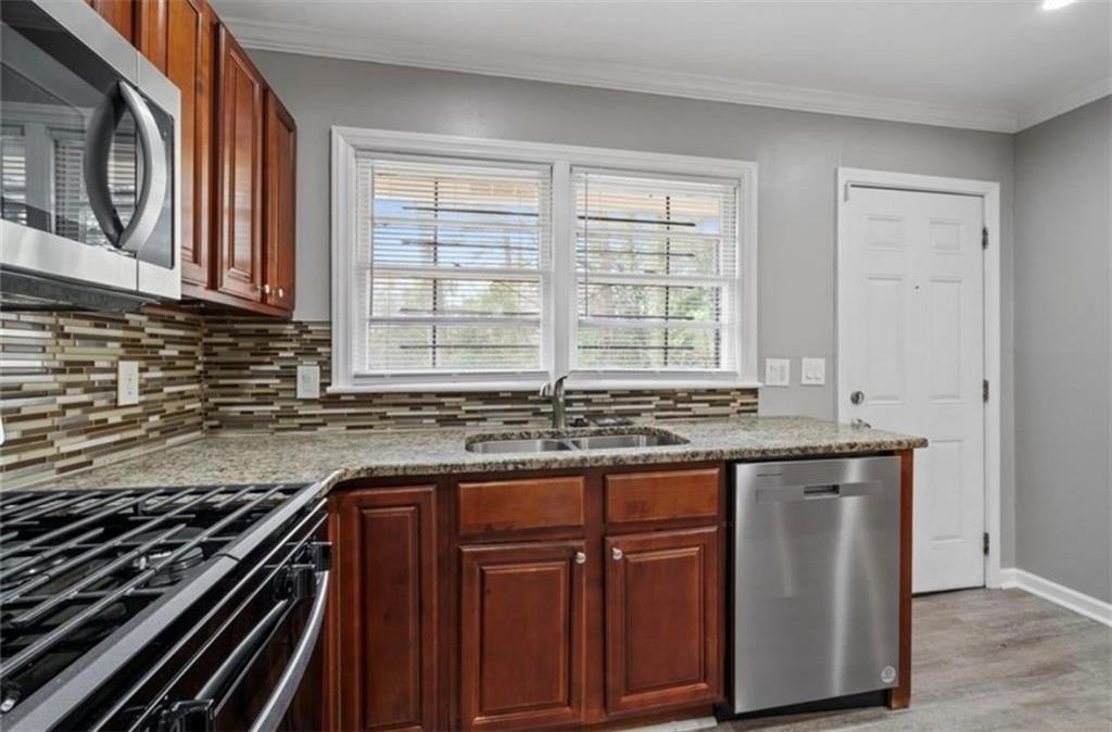 2911 Gresham Rd S East Atlanta, GA 30316 - Photo 11 of 22 a kitchen with granite countertop a stove and a sink