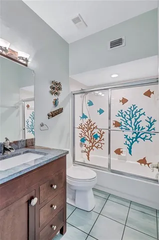 a view of swimming pool with lawn chairs and plants